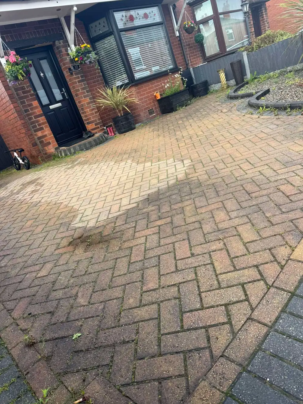 Faded herringbone block driveway before cleaning
