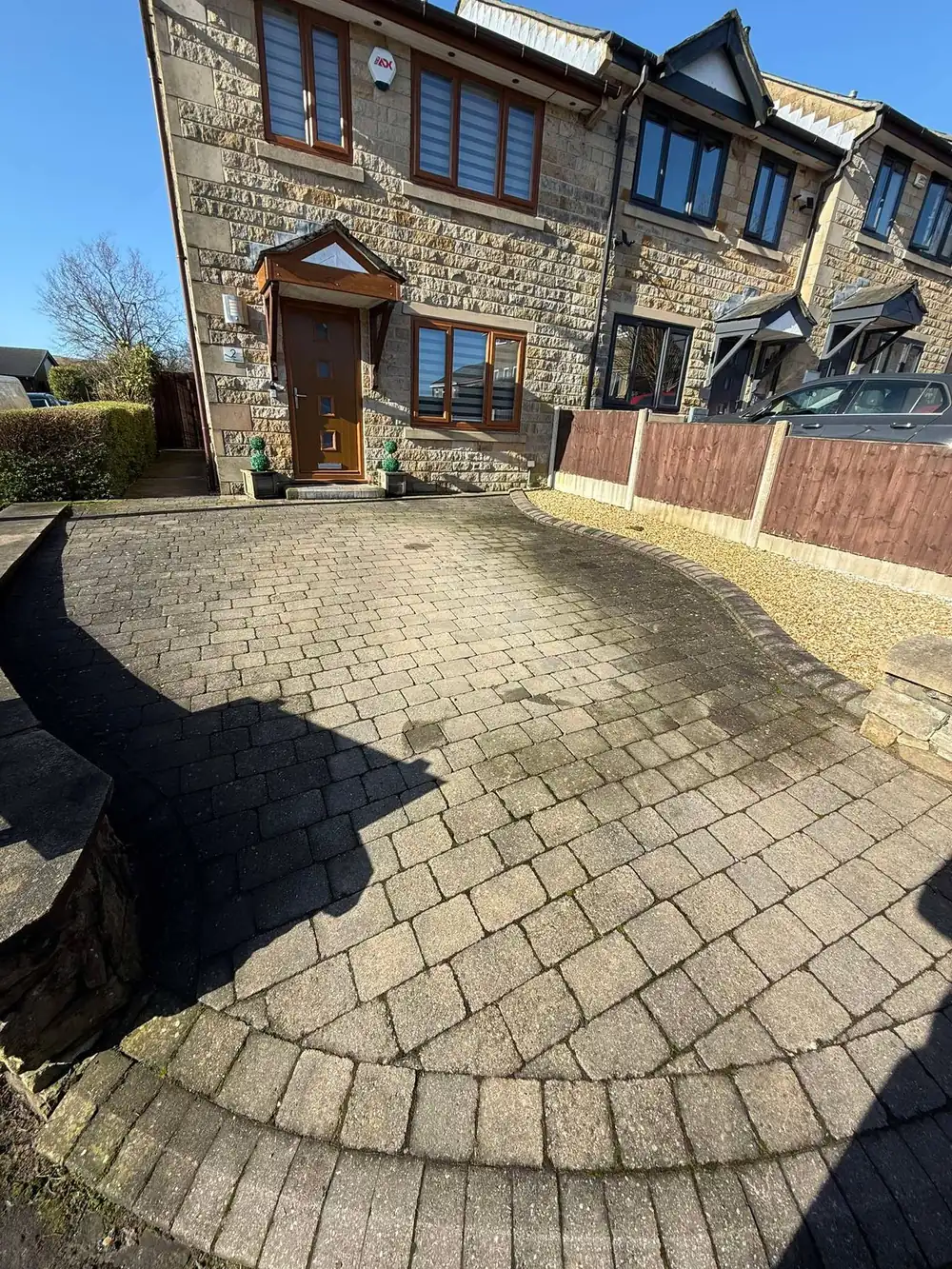 Grey, weathered block paving driveway before cleaning