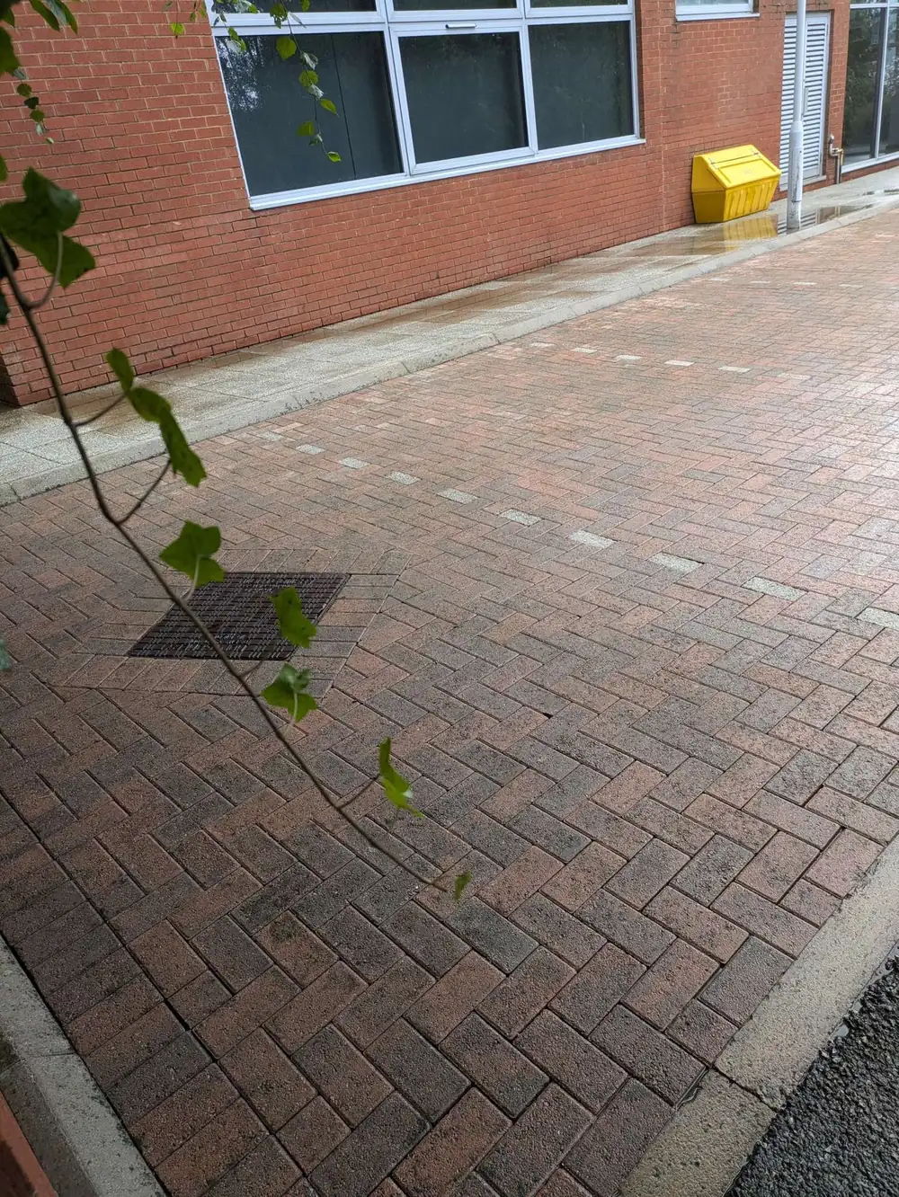 The same commercial paving after cleaning, red block restored