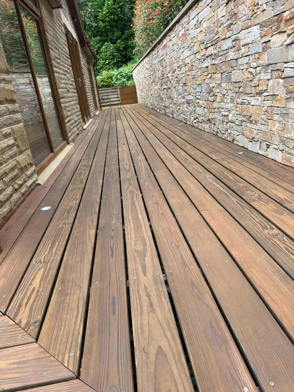 The same boardwalk after cleaning, rich timber colour restored
