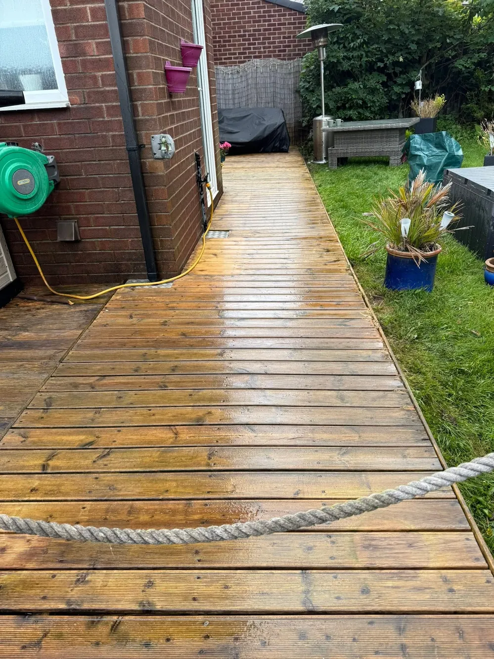 The same decking walkway after cleaning, rich timber colour back