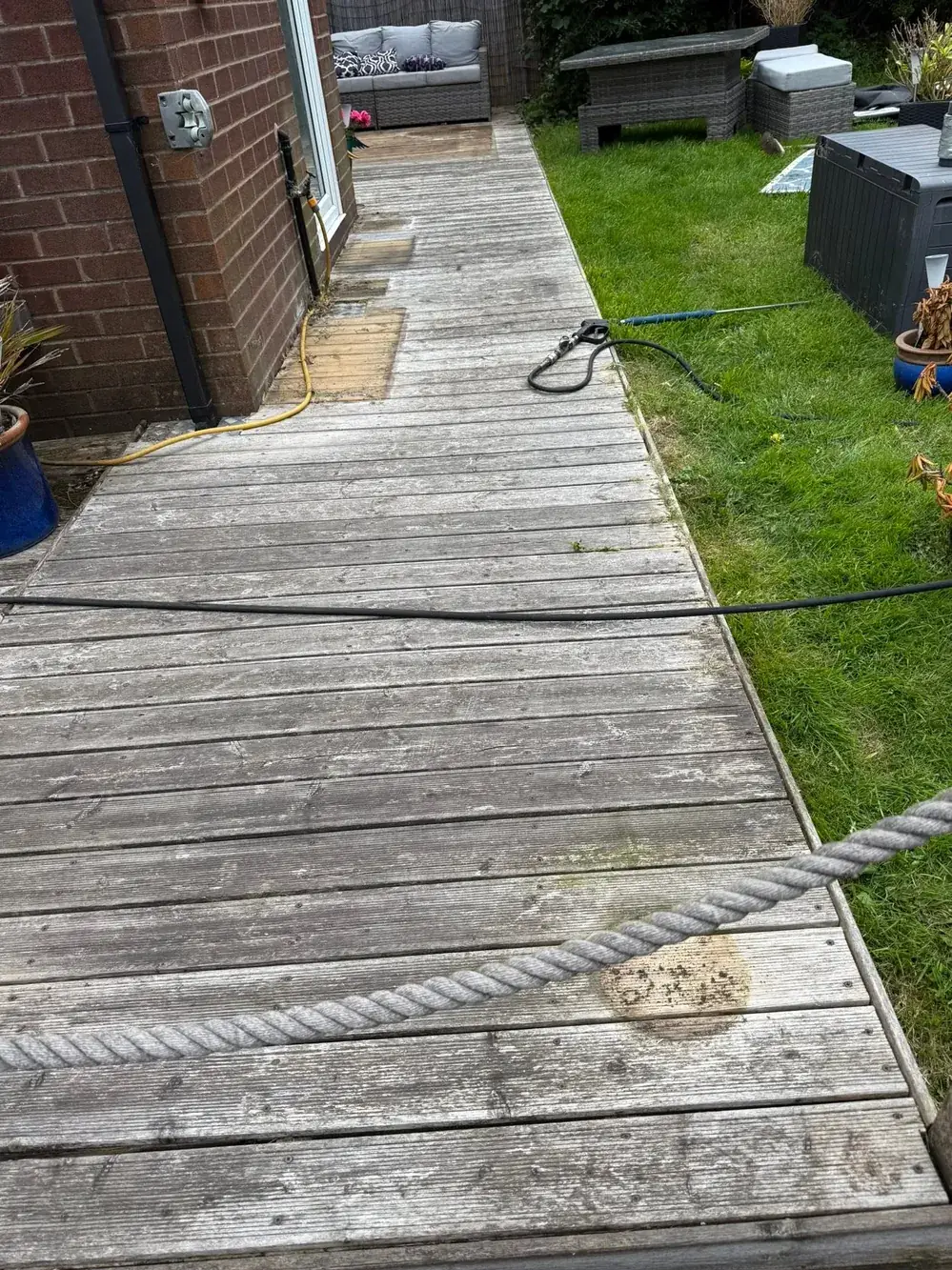 Grey, weathered timber decking walkway before cleaning