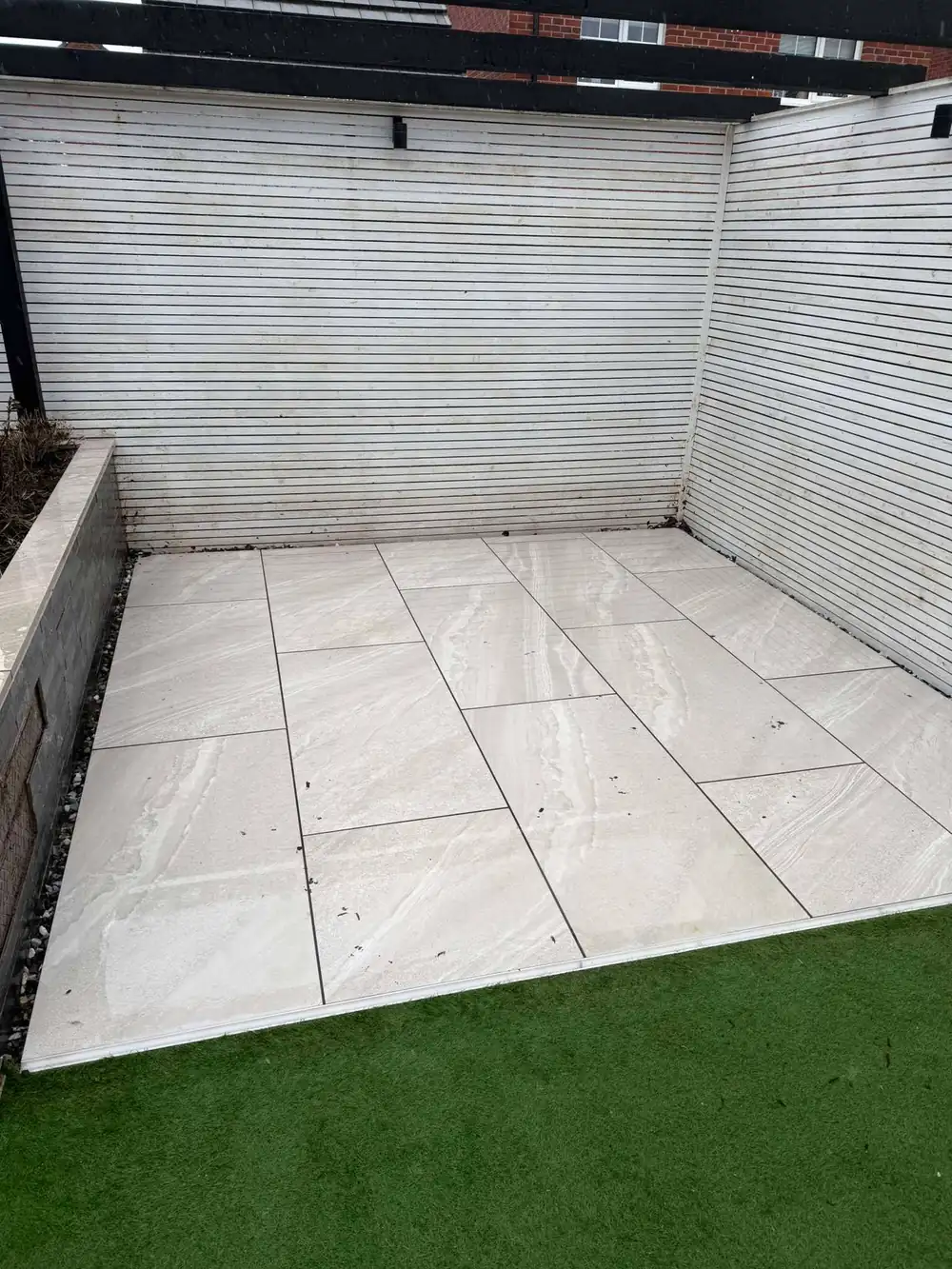 The same porcelain patio after cleaning, clean grey finish