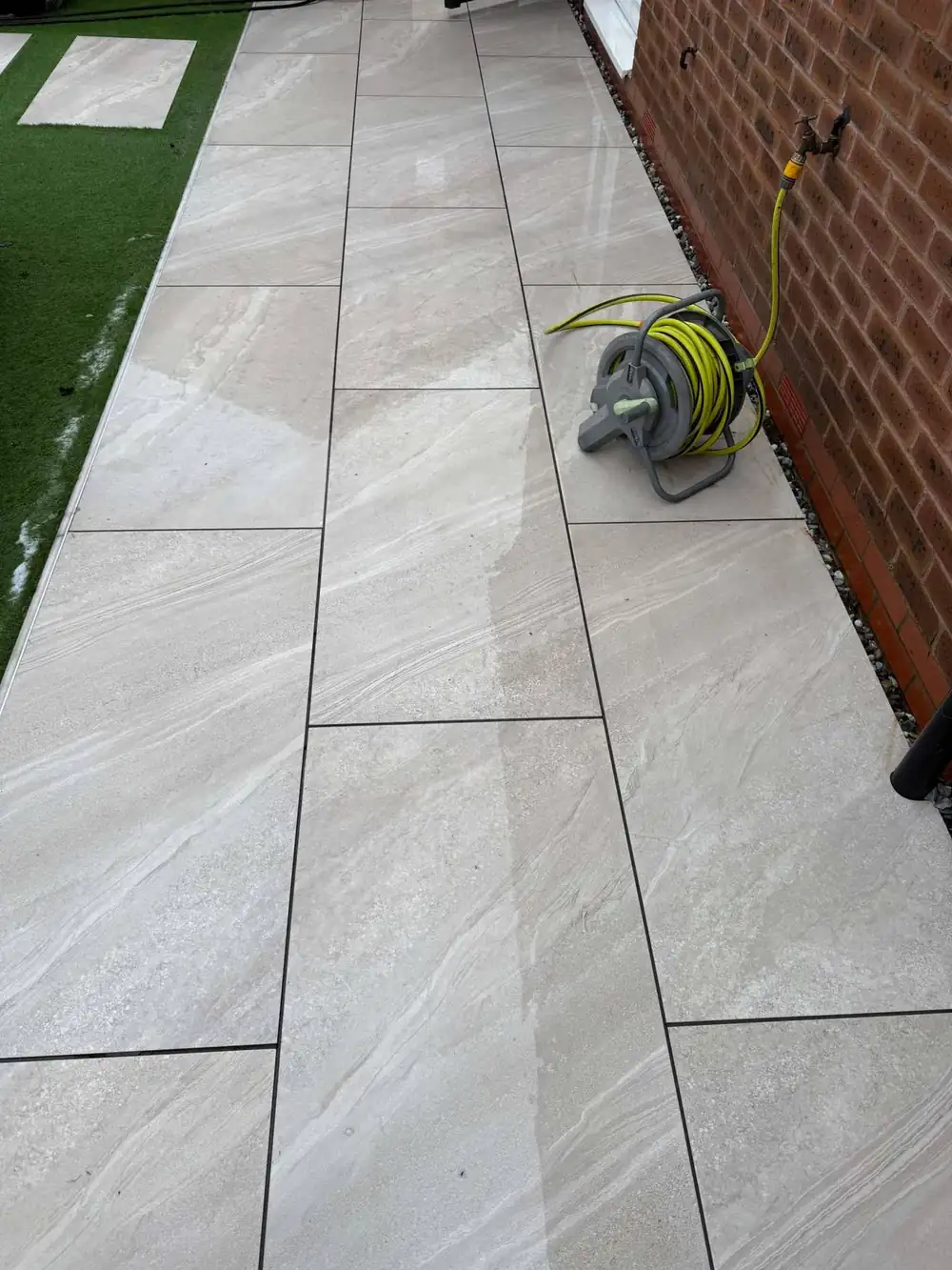 The same porcelain path after cleaning, spotless grey slabs