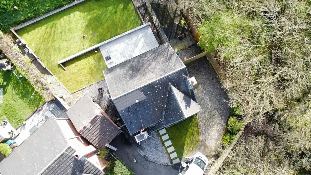 Mossy, stained roof before cleaning, drone photo