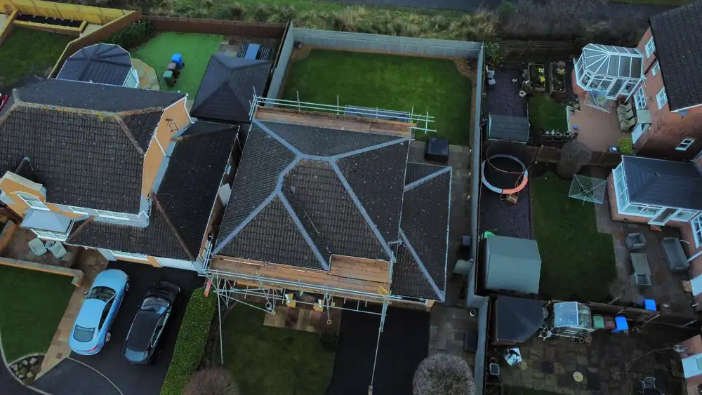 Dark, moss-covered roof before cleaning, drone photo