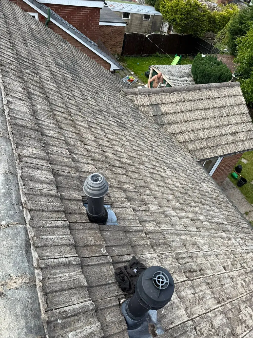 The same roof tiles after cleaning and moss removal
