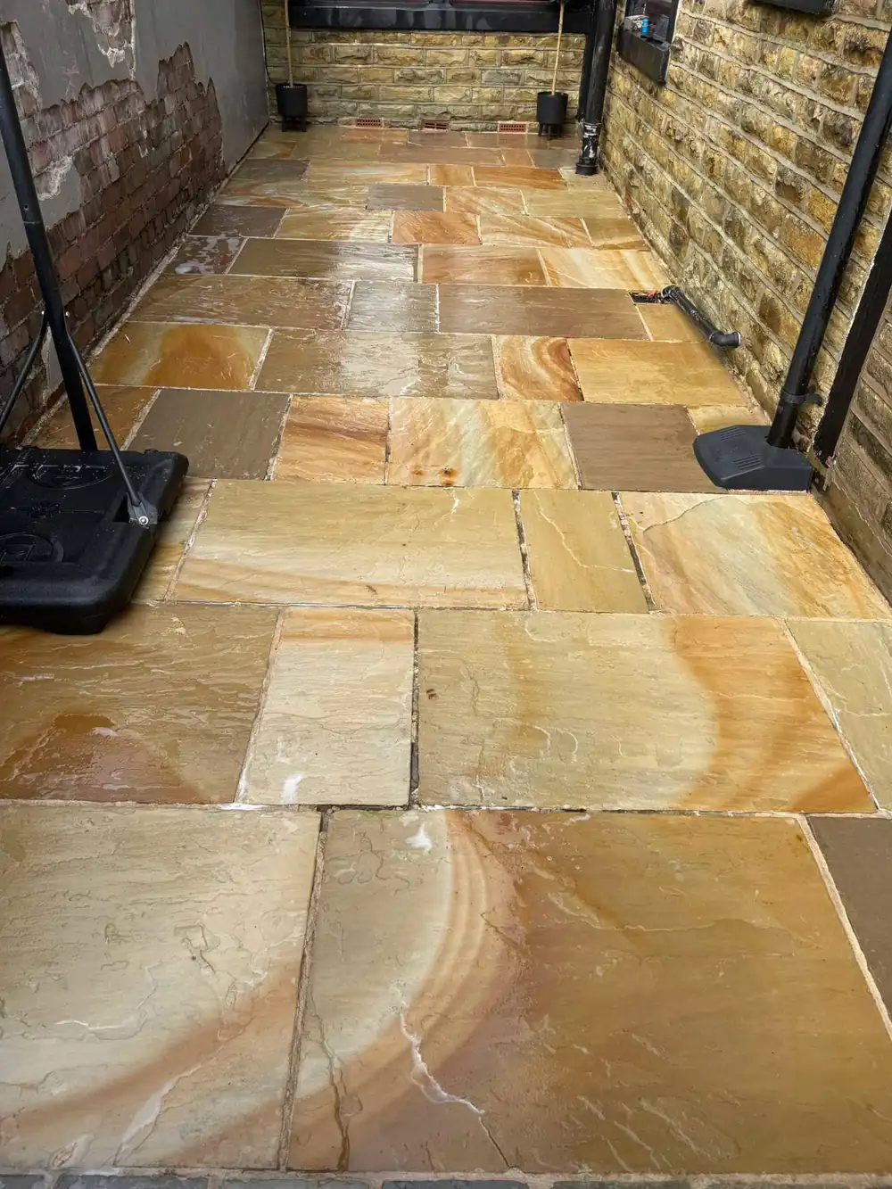 The same riven sandstone flags after cleaning, autumn colour restored