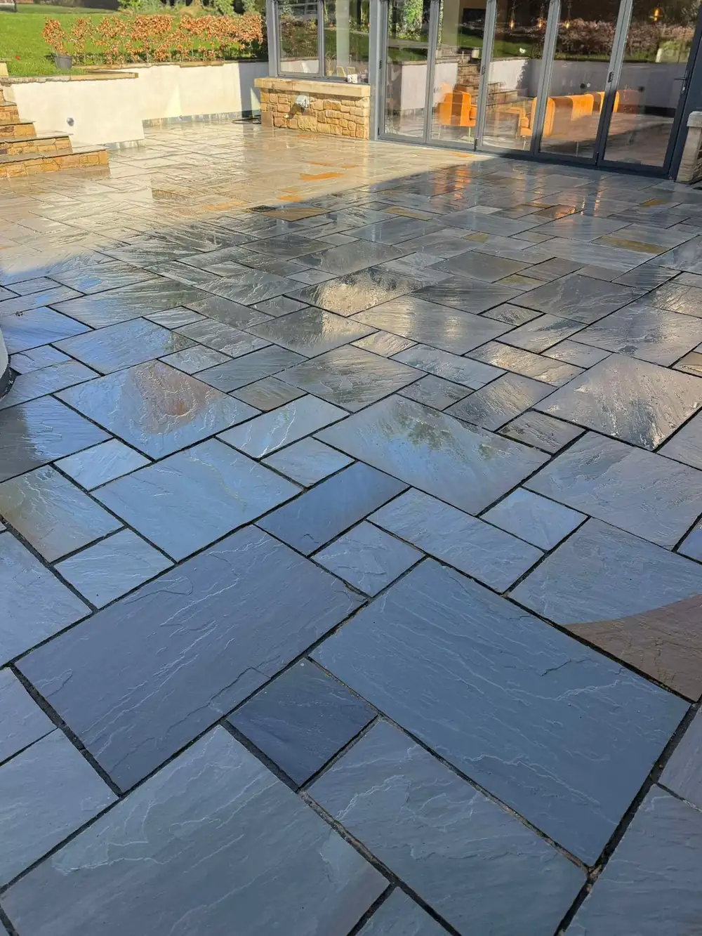 The same Indian sandstone patio after cleaning, natural colour restored