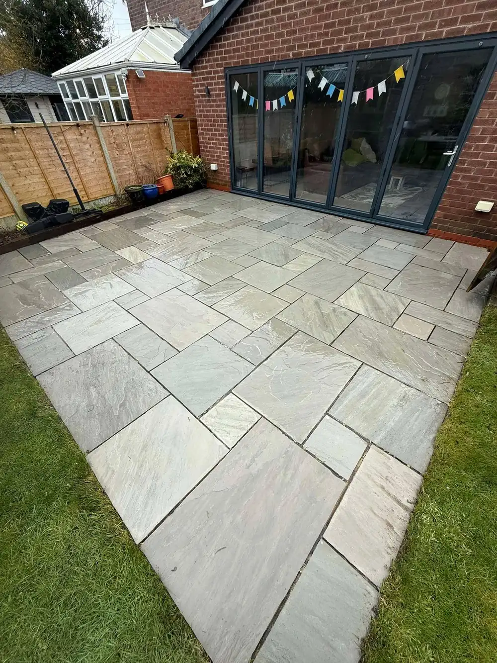 The same sandstone patio after cleaning in Bolton, grey tones back
