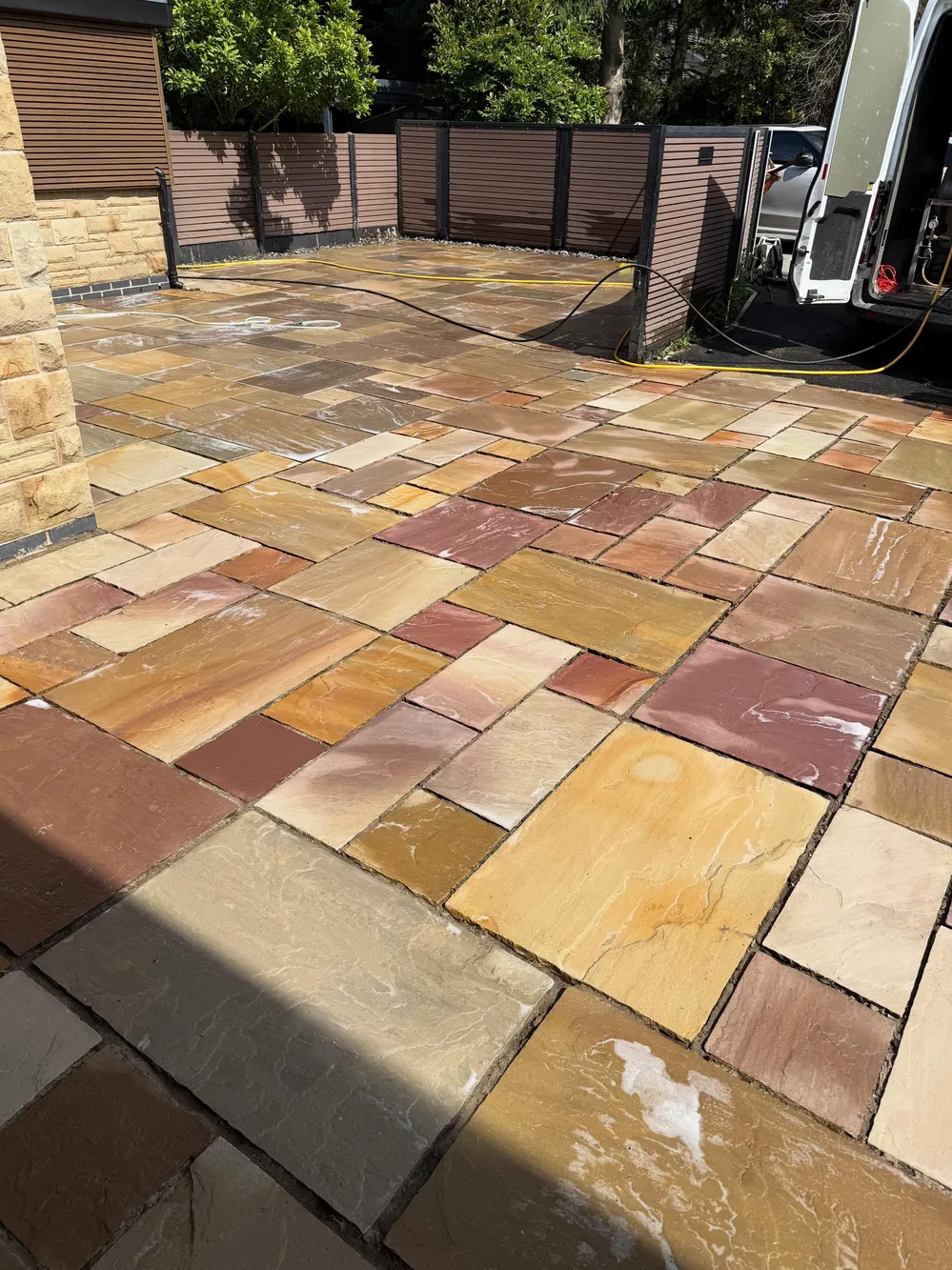 The same patio after cleaning, vivid multi-colour sandstone revealed