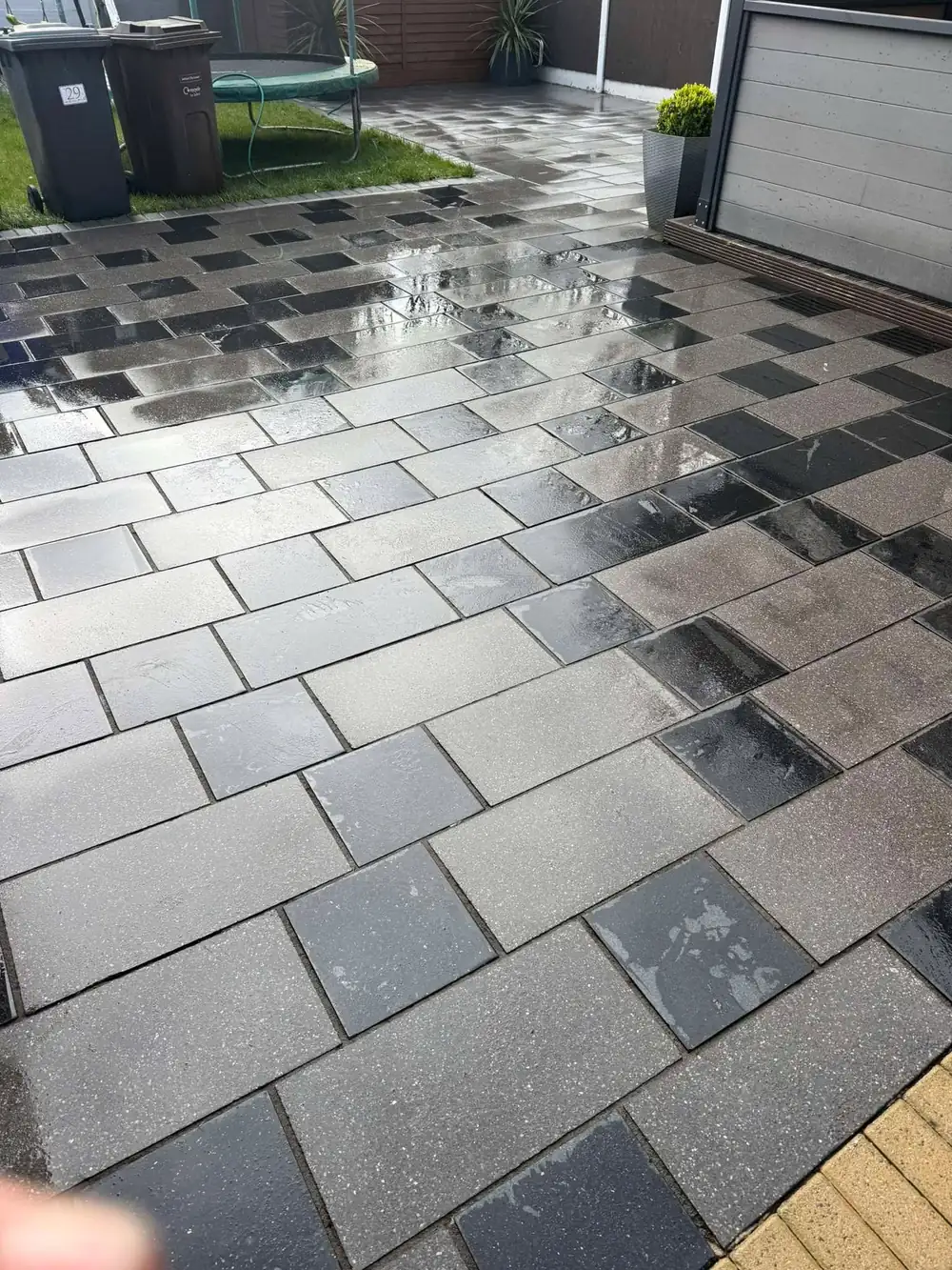 The same charcoal slate patio after cleaning, deep black restored