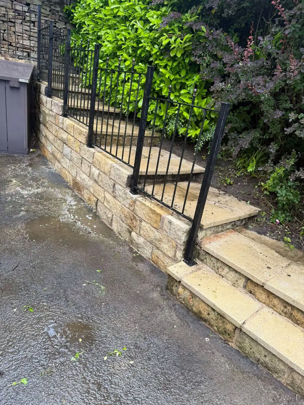 The same stone wall and steps after cleaning, buff stone restored